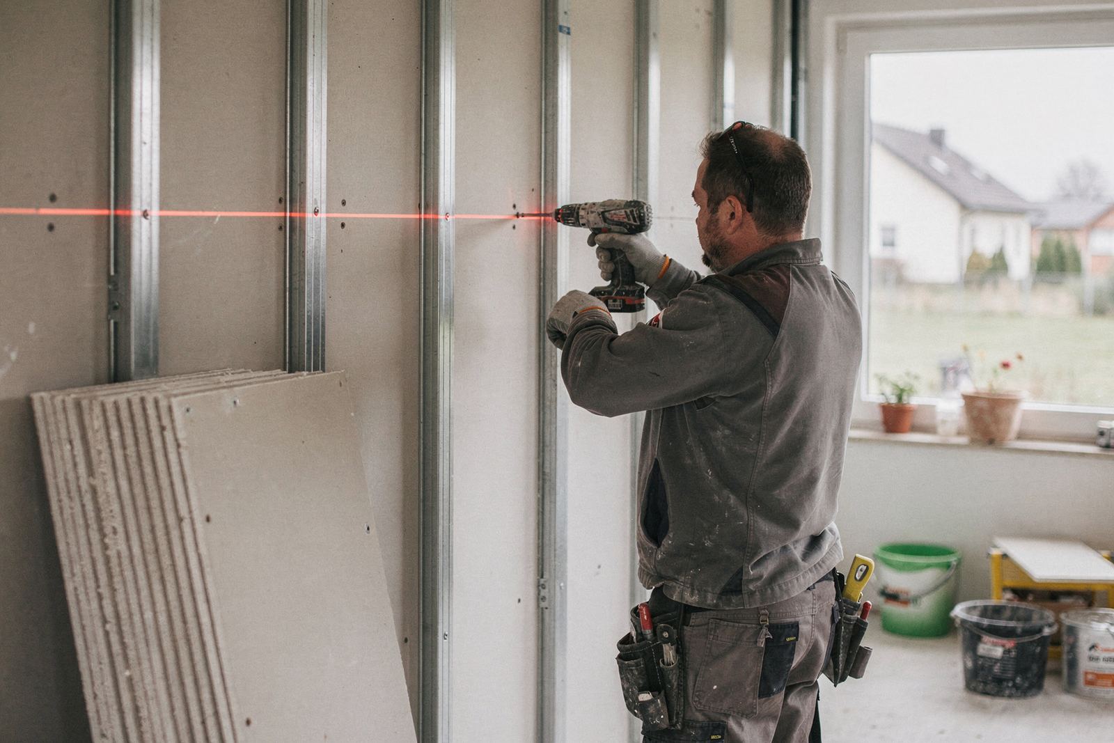 Symbolbild: Trockenbauwand wird mit Gipskarton beplankt